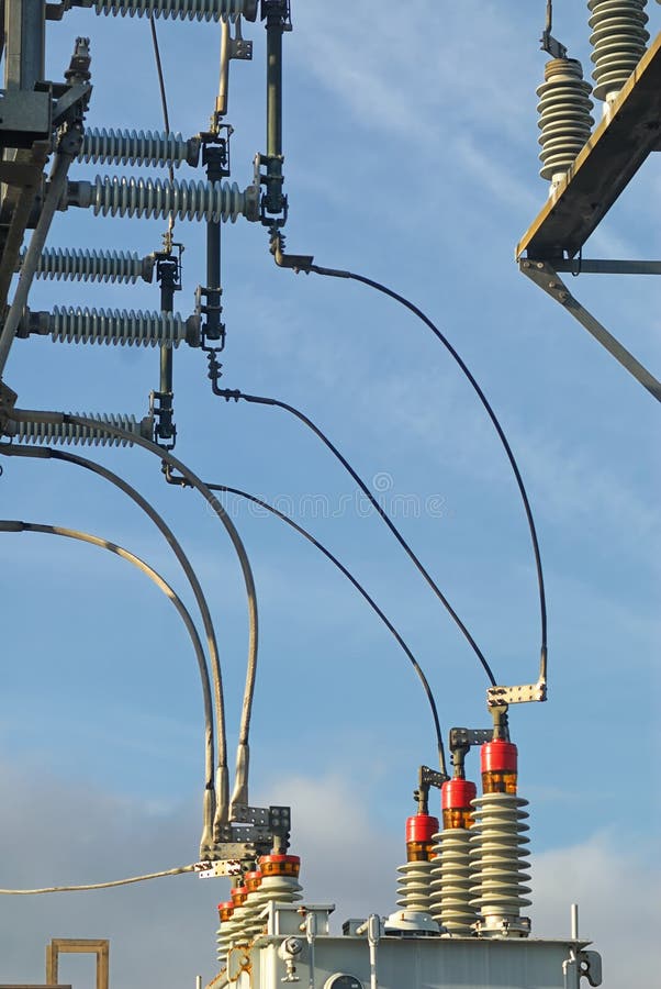 Curving power lines from transmission to distribution in a sub station. royalty free stock images Curving power lines from transmission to distribution in a sub station. royalty free stock images