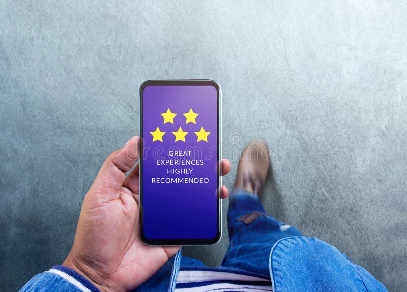 Customer Experiences Concept. Five Stars Rating and Positive Review show on Smartphone`s Screen. a Modern Man Reading Client`s Satisfaction Surveys via Mobile Phone. Top View