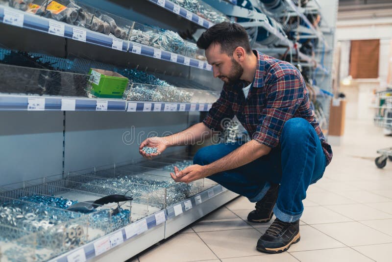 A Customer in a Hardware Store Chooses Selftapping Screws, Screws and