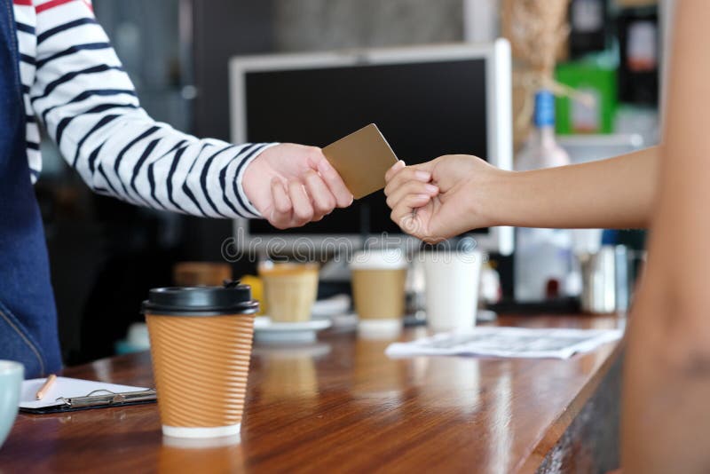 Customer paying coffee by credit, debit electronic card at cafe royalty free stock photography Customer paying coffee by credit, debit electronic card at cafe royalty free stock photography