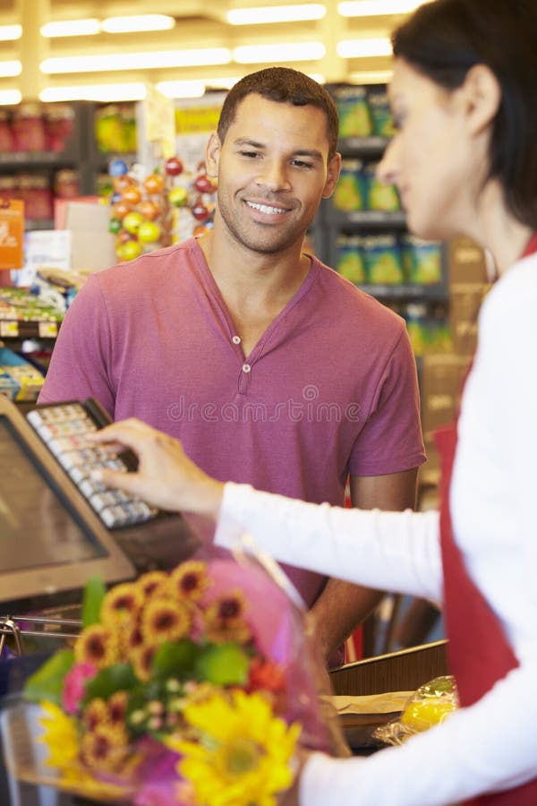 Customer Paying For Shopping At Supermarket Checkout