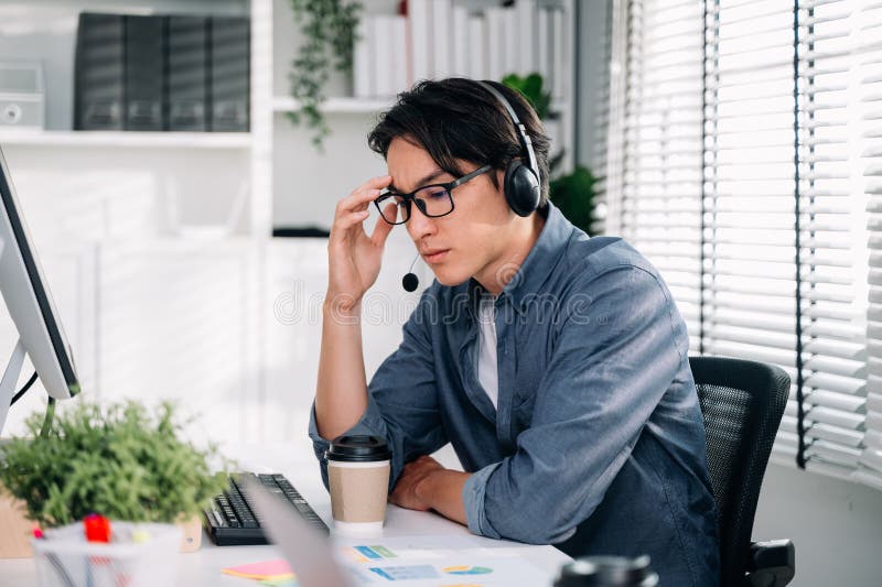 Customer Service Operator with Headsets Working at Call Centre Stock