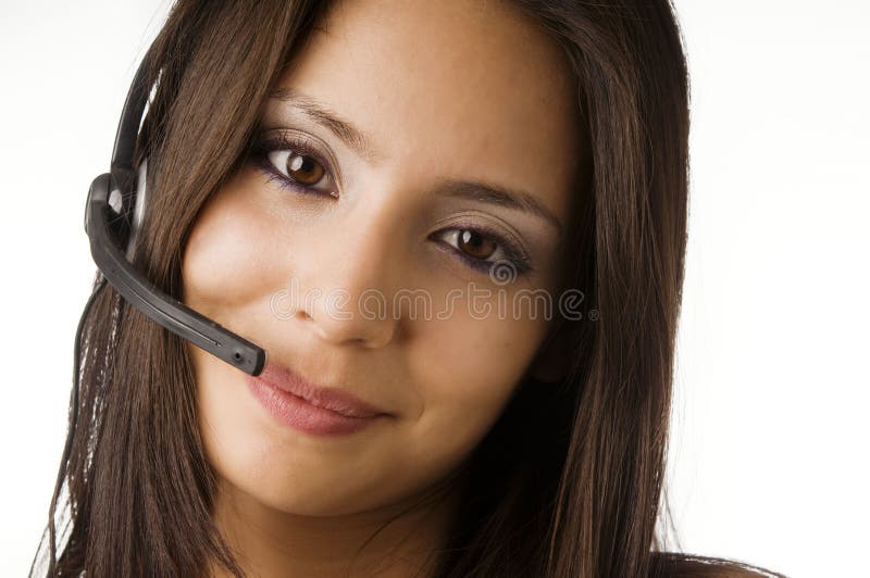 Attractive friendly customer service representative at work answering phone calls using a headset