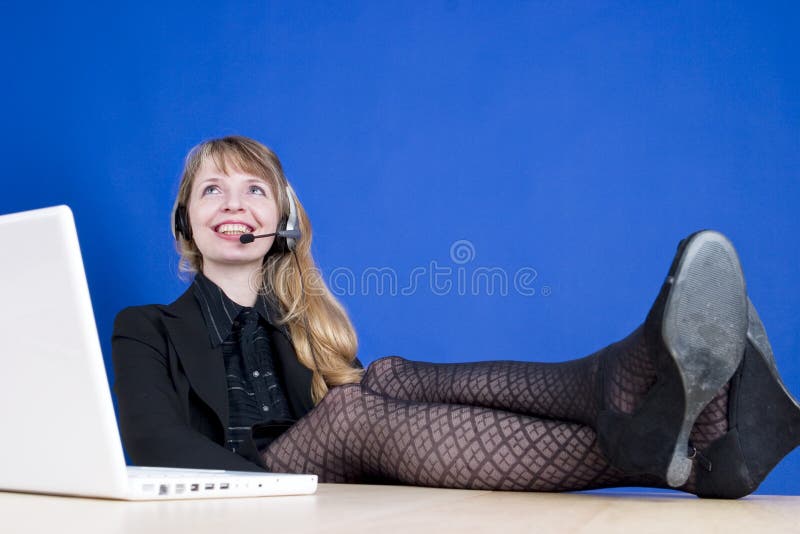 A customer service representative smiling during a telephone conversation