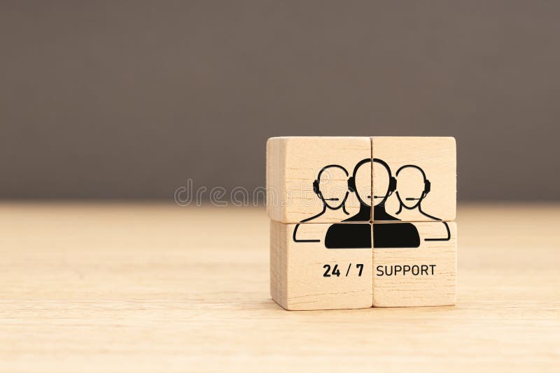 24-7 Customer support concept. Group of wooden block with Group of Call Center Workers icon stock image
