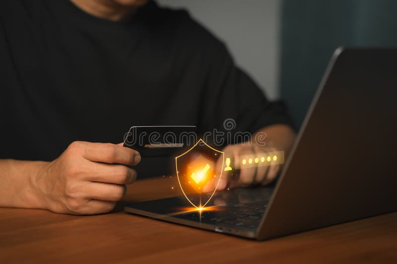 Customer using laptop computer and credit card with security shield, representing online payment protection, shopping online stock photos