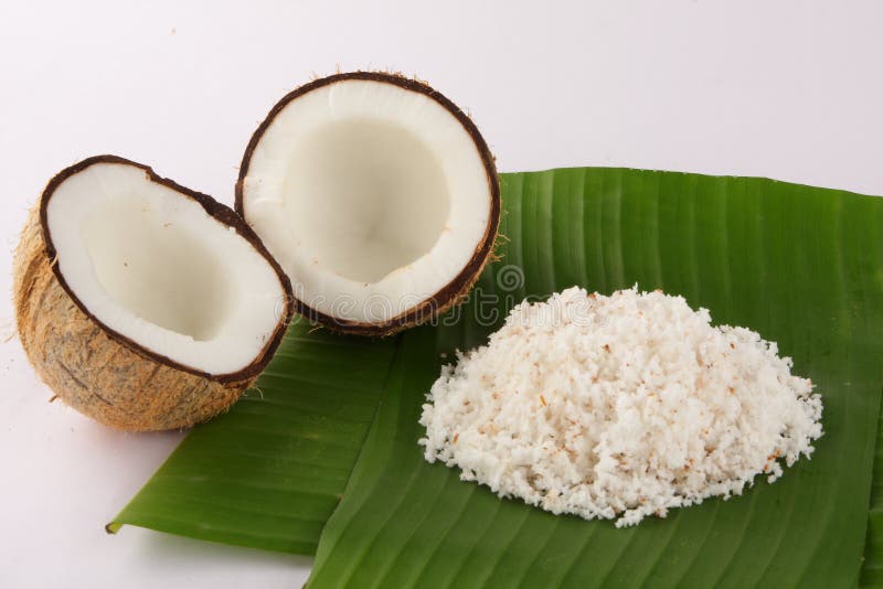 Cut coconuts with coconut leaves and Shredded coconut served in banana leaf.