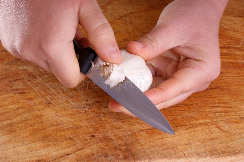 Cut garlic, two hands and a knife