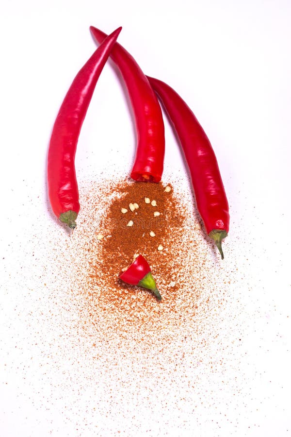 Cut in Half Red Chili Peppers with Ground Red Chili Peppers Stock Photo