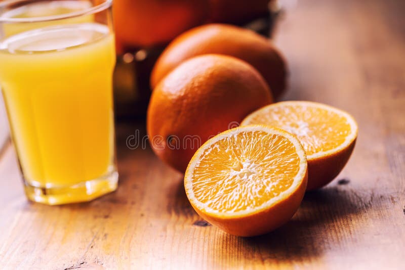 Cut oranges. Pressed orange manual method. Oranges and sliced oranges with juice and squeezer. stock photos