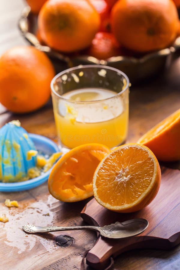 Cut oranges. Pressed orange manual method. Oranges and sliced oranges with juice and squeezer. stock images