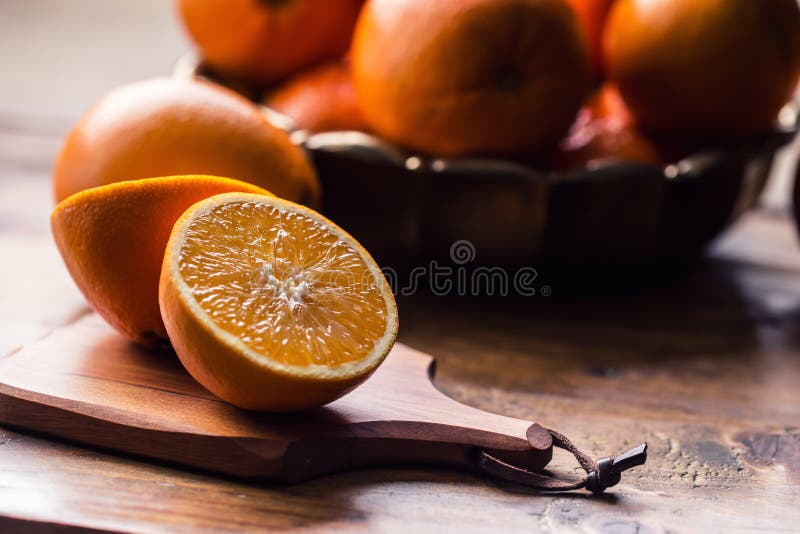 Cut oranges. Pressed orange manual method. Oranges and sliced oranges with juice and squeezer. stock photos