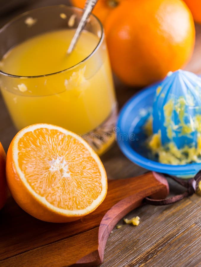 Cut oranges. Pressed orange manual method. Oranges and sliced oranges with juice and squeezer. royalty free stock photo