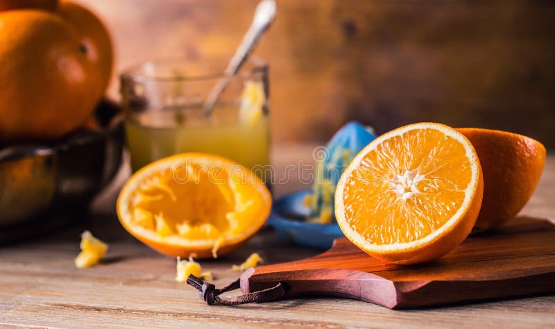 Cut oranges. Pressed orange manual method. Oranges and sliced oranges with juice and squeezer. royalty free stock photo