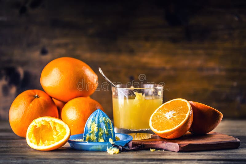 Cut oranges. Pressed orange manual method. Oranges and sliced oranges with juice and squeezer. stock photos