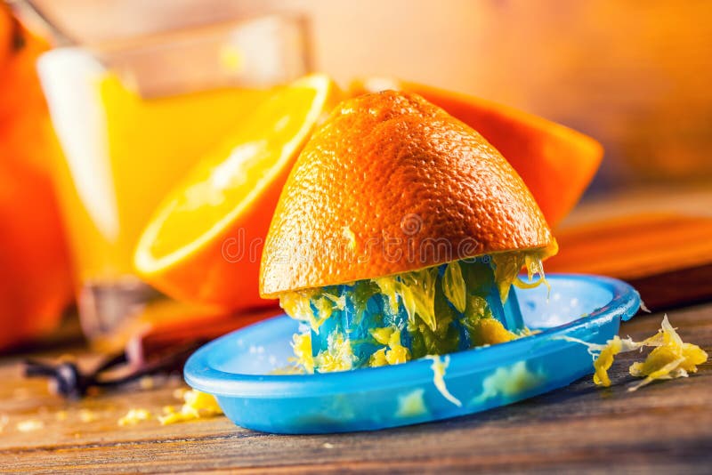 Cut oranges. Pressed orange manual method. Oranges and sliced oranges with juice and squeezer. royalty free stock photo