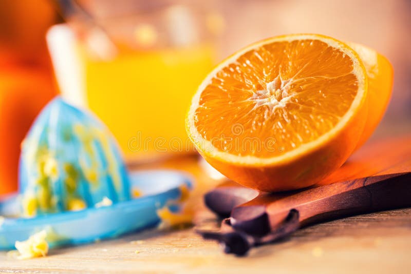 Cut oranges. Pressed orange manual method. Oranges and sliced oranges with juice and squeezer. royalty free stock photography