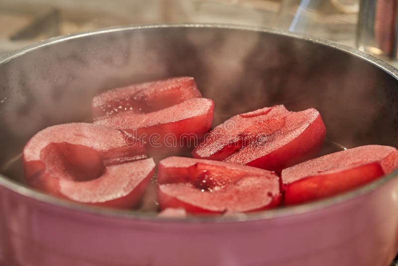Cut Pears are Boiled in Red Syrup with Wine on Gas Stove Stock Photo