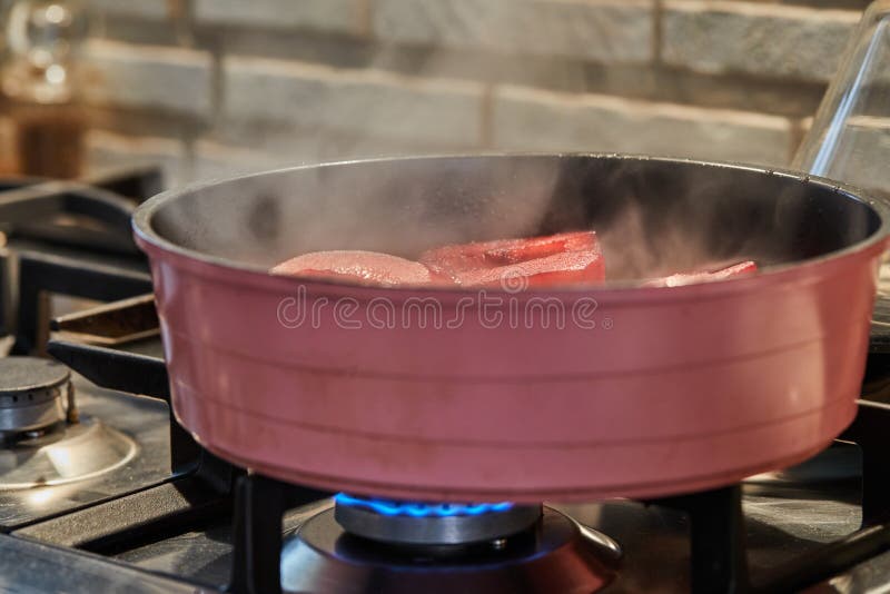Cut Pears are Boiled in Red Syrup with Wine on Gas Stove Stock Image