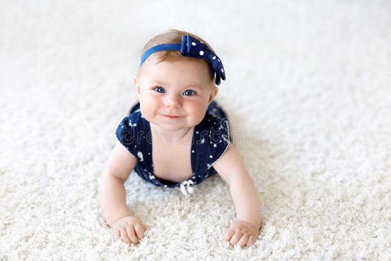 Cute adorable baby girl in blue clothes and headband. royalty free stock images