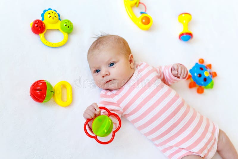 Cute Baby Girl Playing with Colorful Rattle Toys Stock Photo - Image of ...