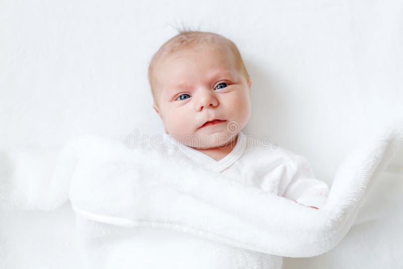 Cute Adorable Newborn Baby In White Bed And Wrapped In ...