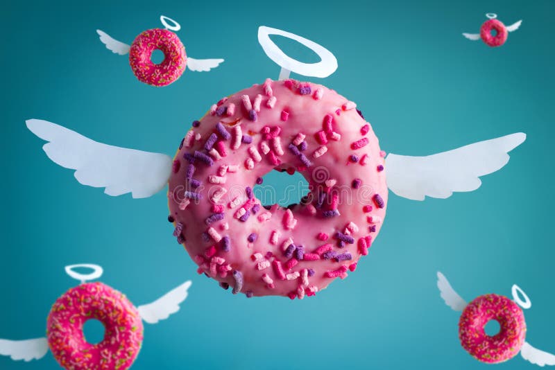 Angel donuts with white paper wings and nimbus on a blue background,cute festive card