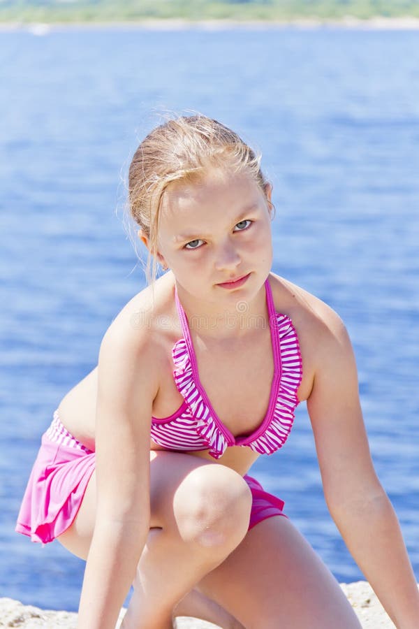 Cute angry girl in pink swimsuit stock photo Cute angry girl in pink swimsuit stock photo