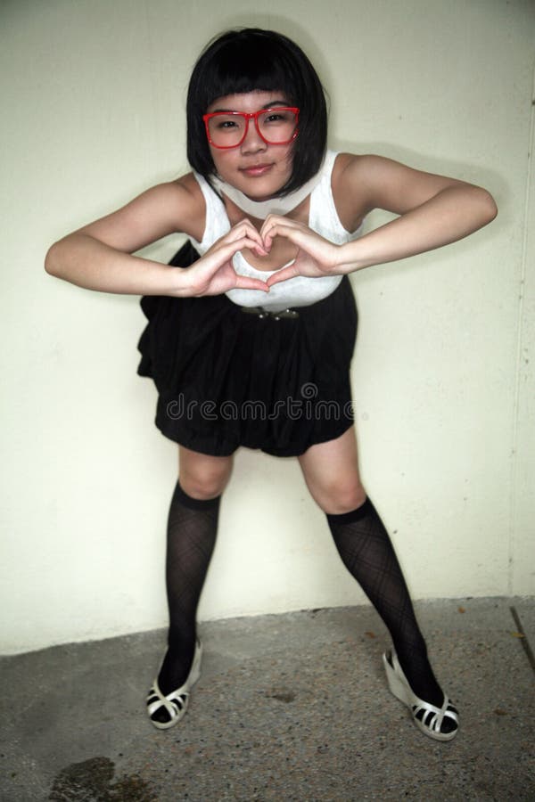 Cute Asian girl making a heart shape