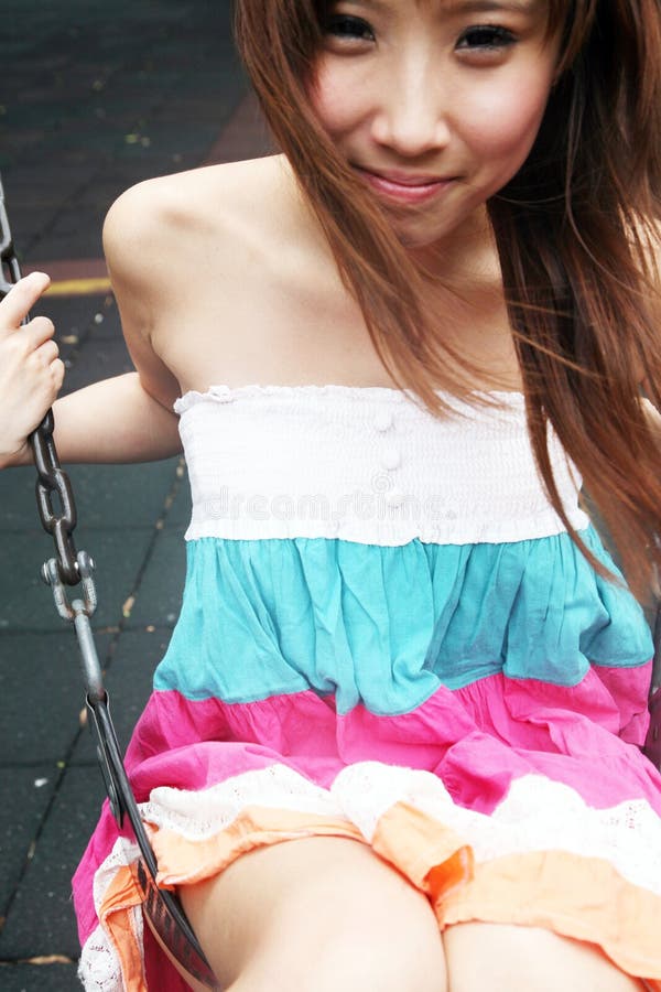 Cute Asian girl on a swing