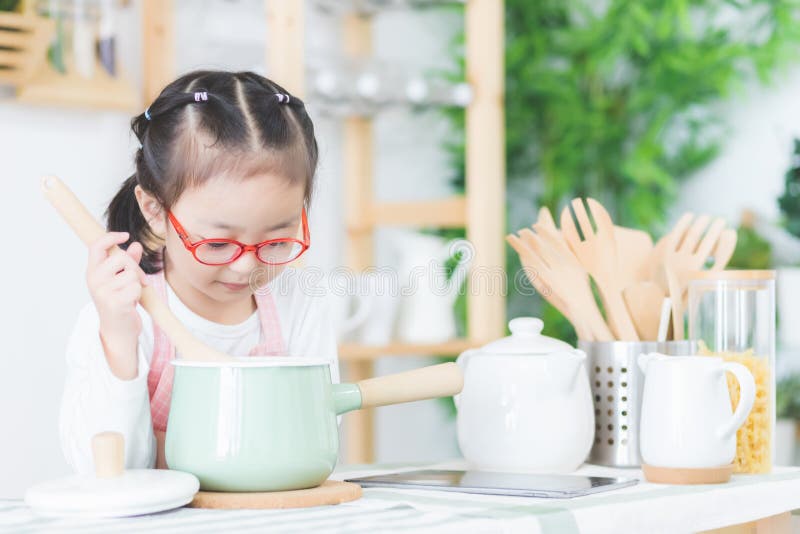 Cute Asian girls, Thai people are cooking in the kitchen at his home. royalty free stock images Cute Asian girls, Thai people are cooking in the kitchen at his home. royalty free stock images