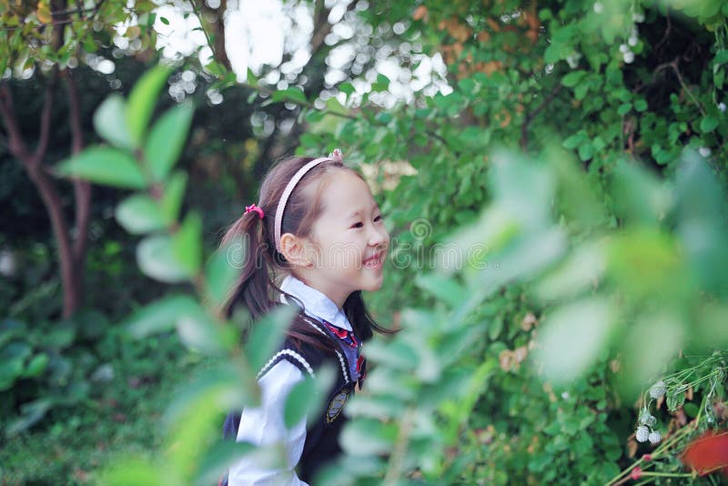 Cute Asian little beautiful girl smell flower stock photos Cute Asian little beautiful girl smell flower stock photos