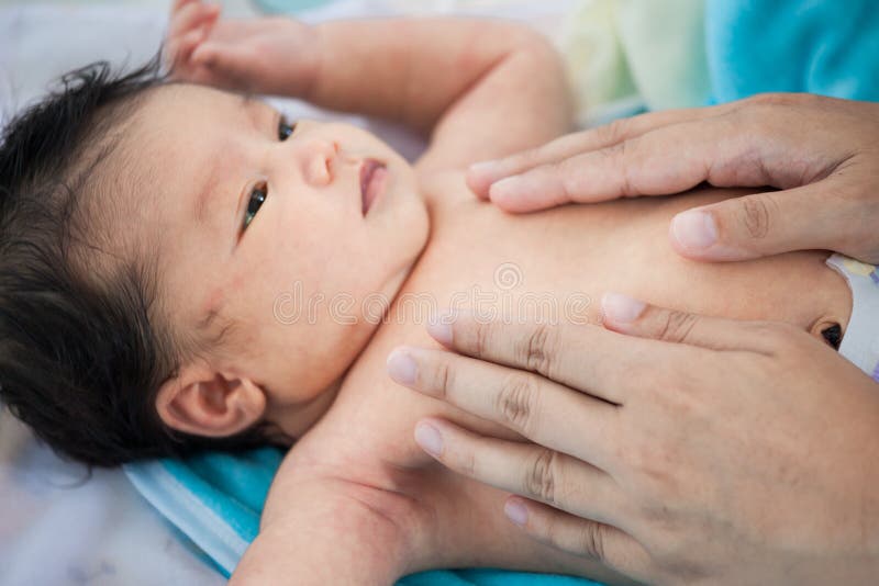 Cute asian newborn baby massage. royalty free stock images Cute asian newborn baby massage. royalty free stock images