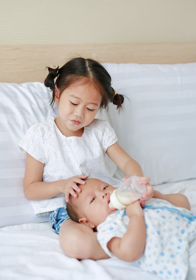 https://thumbs.dreamstime.com/b/cute-asian-sister-feeding-milk-bottle-her-brother-lying-bed-cute-asian-sister-feeding-milk-bottle-her-197839306.jpg