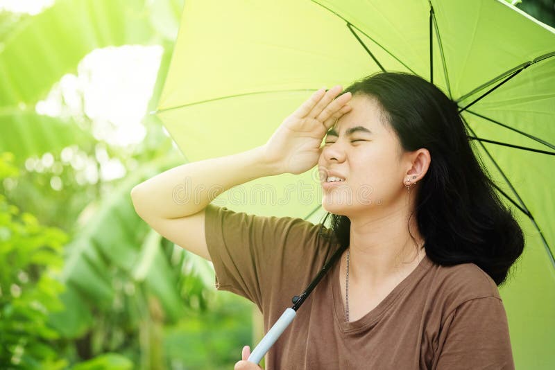 Cute asian woman holding umbrella with sunlight in the hot weather royalty free stock images Cute asian woman holding umbrella with sunlight in the hot weather royalty free stock images