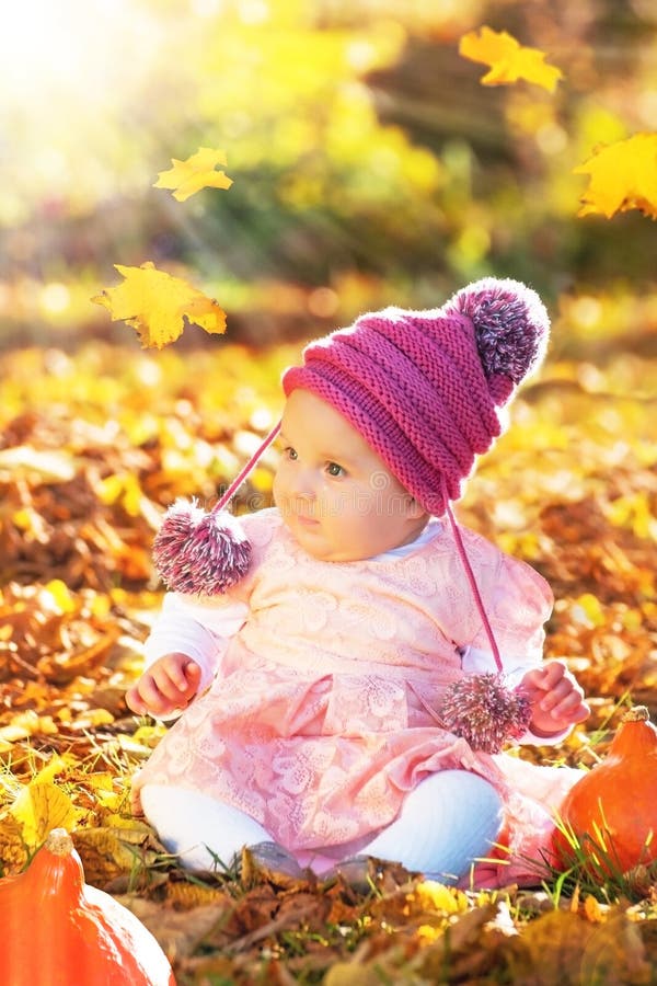 Carino felice curioso sorridente neonato ragazza in autunno ritratto.