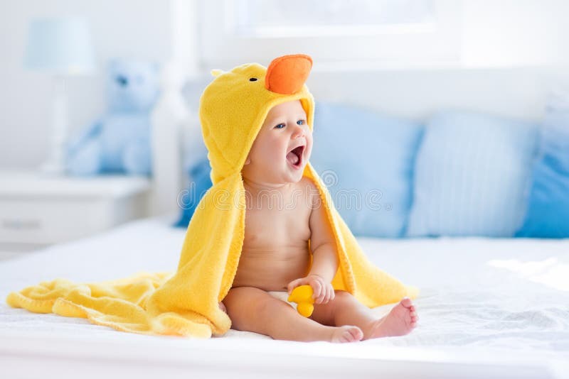Cute baby after bath in yellow duck towel
