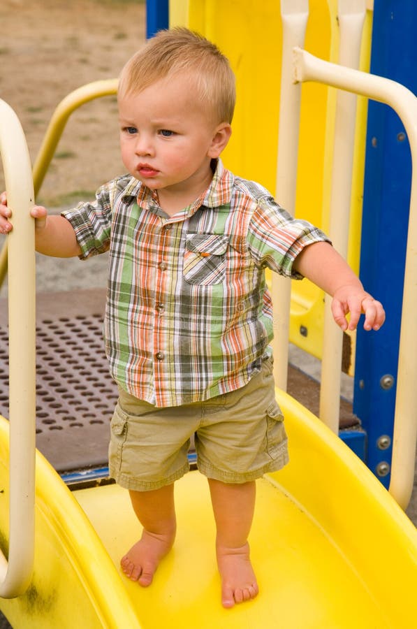 Cute Little Asian Boy Child Sitting and Concentrate on Putting on His ...