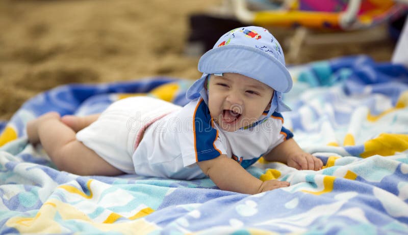 Cute baby boy on a beach towel
