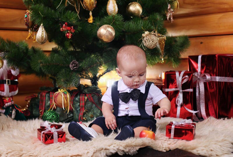 Cute baby boy with Christmas gifts stock photography Cute baby boy with Christmas gifts stock photography
