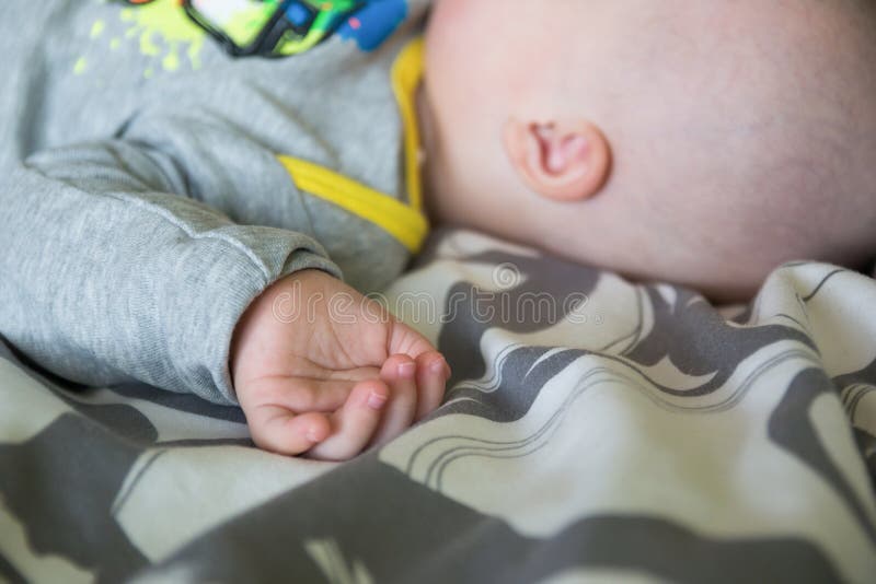 Cute baby boy with Down syndrome sleeping on the bed royalty free stock image Cute baby boy with Down syndrome sleeping on the bed royalty free stock image