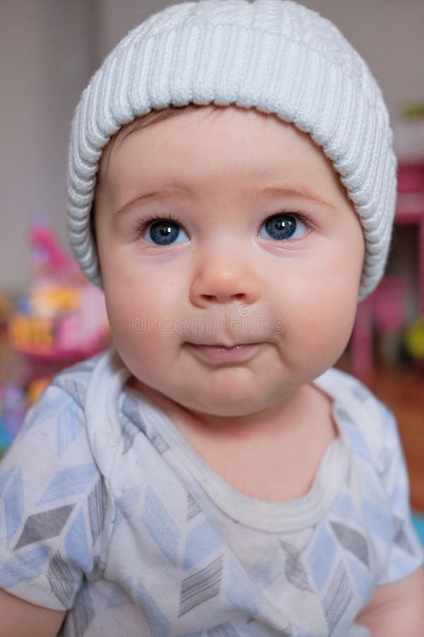 Cute Baby Boy in a Hat Making Funny Faces at Home Stock Photo Image
