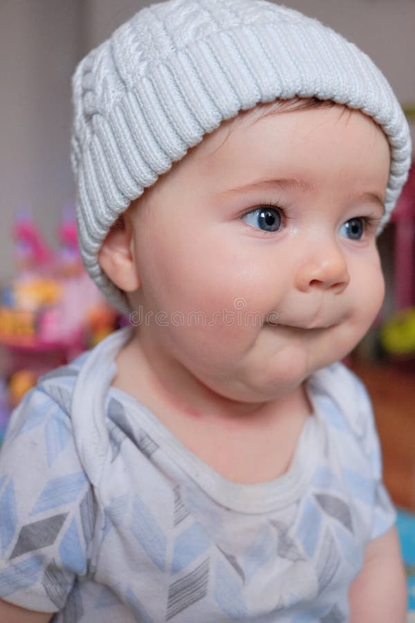 Cute Baby Boy in a Hat Making Funny Faces at Home Stock Photo Image