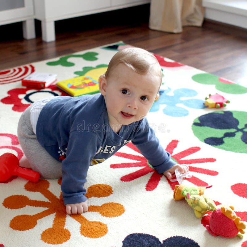 Cute baby boy on play mat royalty free stock images