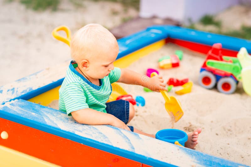 Cute baby boy playing in the sandbox stock image Cute baby boy playing in the sandbox stock image