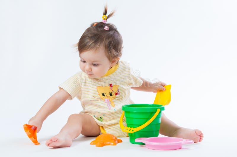 Cute baby with bucket and spade isolated on white background