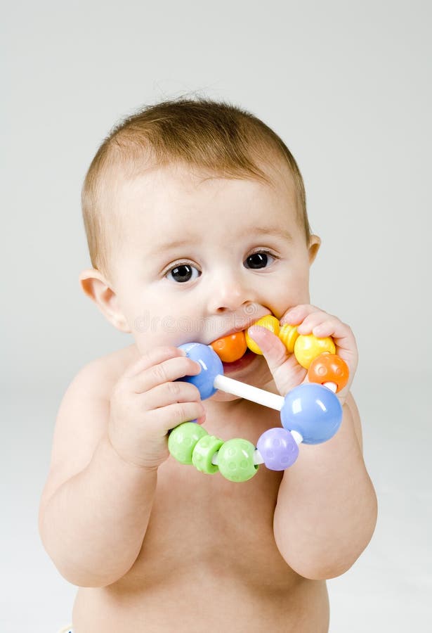 Cute Baby Chewing on Toy stock image. Image of face, caucasian 17095241