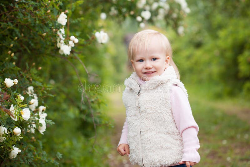 Cute Baby Girl with Blonde Hair in the Blooming Garden Stock Image ...