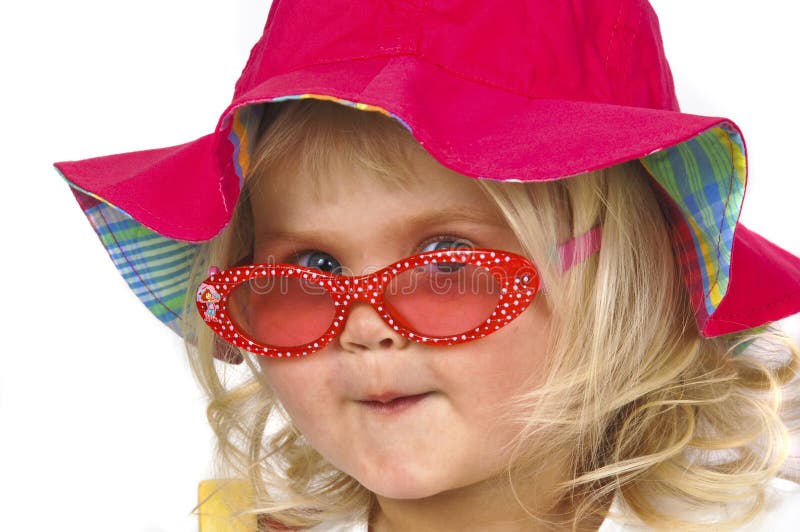 Cute baby girl in a red hat and sunglasses.