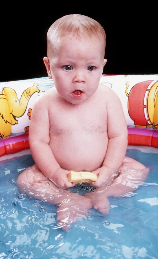 Cute Baby Girl Sitting in a Blow Up Plastic Wading Poo Stock Photo ...